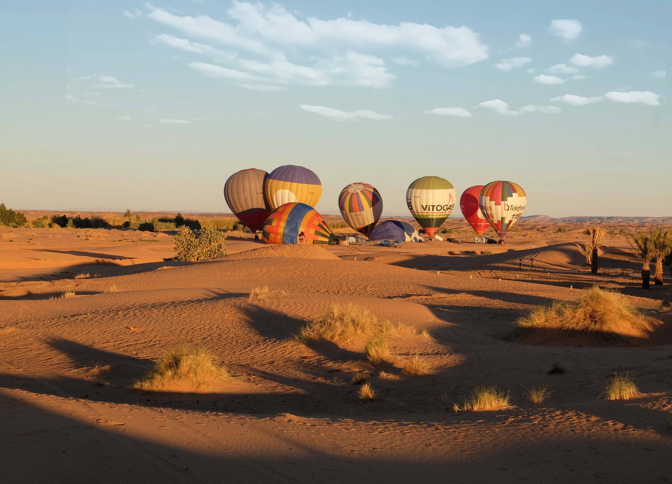Hot-air balloons over the desert at dawn